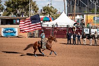 Flag bearer in Phoenix at the All-Indian Rodeo, a featured competition, open only to Native Americans with proof of tribal identification, at the annual Arizona State Fair, which has been held since 1884, eighteen years before statehood, when it was a territorial fair.
