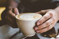 Free man grabbing hot coffee cup photo, public domain beverage CC0 image.