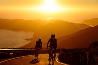 Men Cycling at Sunset 