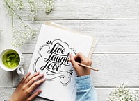 An artist creating hand lettering artwork from motivation quote