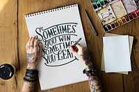 A woman is writing a motivation quote
