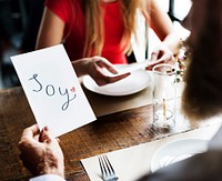 Man reading the word Joy in a restaurant