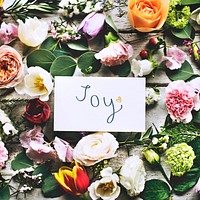 Text Joy on the card and flowers