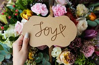 Flower bouquet and a card with a text Joy