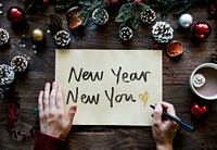 Writing New Year New you on a yellow paper