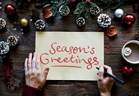 Woman writing a Season's Greetings card