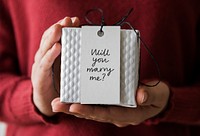 Woman holding a marriage proposal gift
