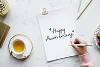Woman writing a Happy Anniversary card