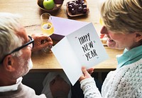 Mature couple holding a New Years card