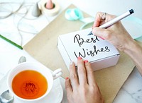 Woman writing Best Wishes on white box
