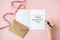 Woman writing a Happy Valentine&#39;s Day card