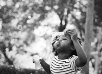 African kid playing with bubbles