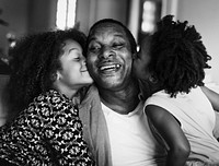 African children kissing their father