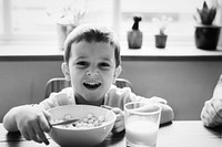 Little boy smiling while eating his breakfast