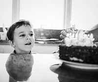 Boy celebrating his birthday with a cake