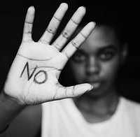 Closeup of girls hand with the word no