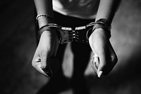 Criminal woman wearing handcuffs around her wrists