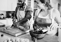 A couple is cooking in the kitchen