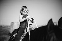 Young girl is enjoying horse riding