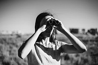 Traveler using binoculars to spot a bird