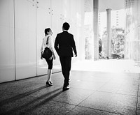 Asian business people in a disussion while walking