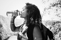 Female traveler drinking water out of a bottle