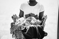 Young teen girl holding a laundry basket