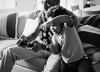 Dad and son playing games in the living room