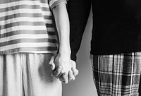 Closeup of couple holding hands together