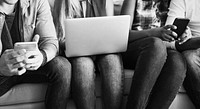 Group of friends using digital devices