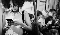 Young woman using a smartphone in a subway