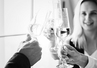 Closeup of people clinking wine glasses