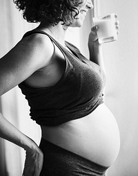 Pregnant woman drinking some milk