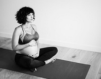 Pregnant woman doing yoga at home