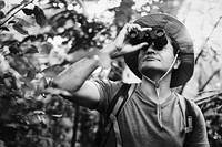 Man using binoculars in the forest