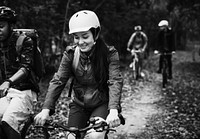 Friends riding a bicycle in the forest