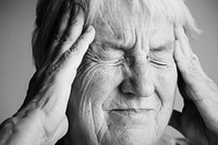 Elderly woman suffering from migraine