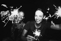 Friends celebrating with sparklers in the night