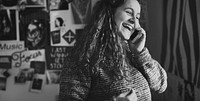 Teenage girl talking on a phone in a bedroom