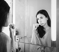 Woman brushing her teeth in the morning