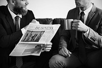 Two businessmen sitting on a couch