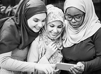 Muslim women looking into a mobile