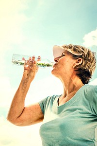 Mature active woman drinking some water