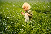 Boy playing in a field of flowers