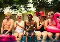 Cool seniors acting youtful by a swimming pool