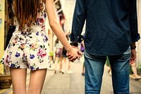 Asian couple holding hands in the city