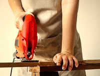 Woman using an electrical saw