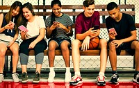 Teenage friends hanging out at a bsaketball court