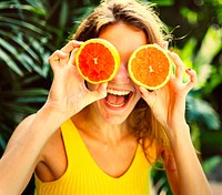 Happy young woman with oranges