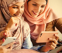 Group of muslim women playing on smartphones